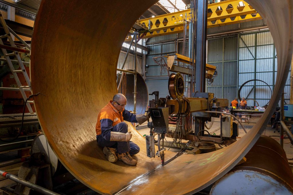 Welder using subarc welder inside large pipe